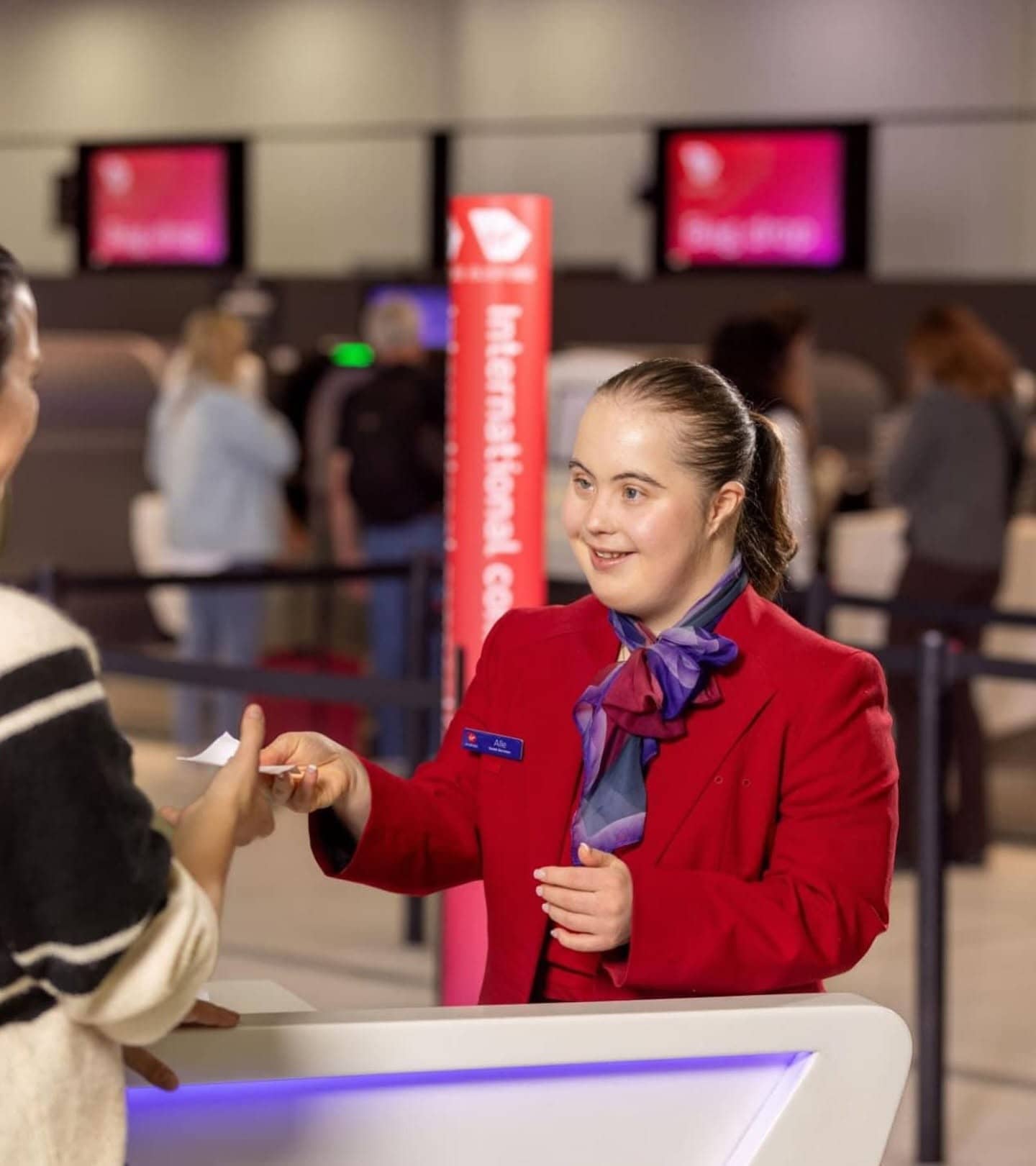 Welcoming a traveller at the airline check-in counter