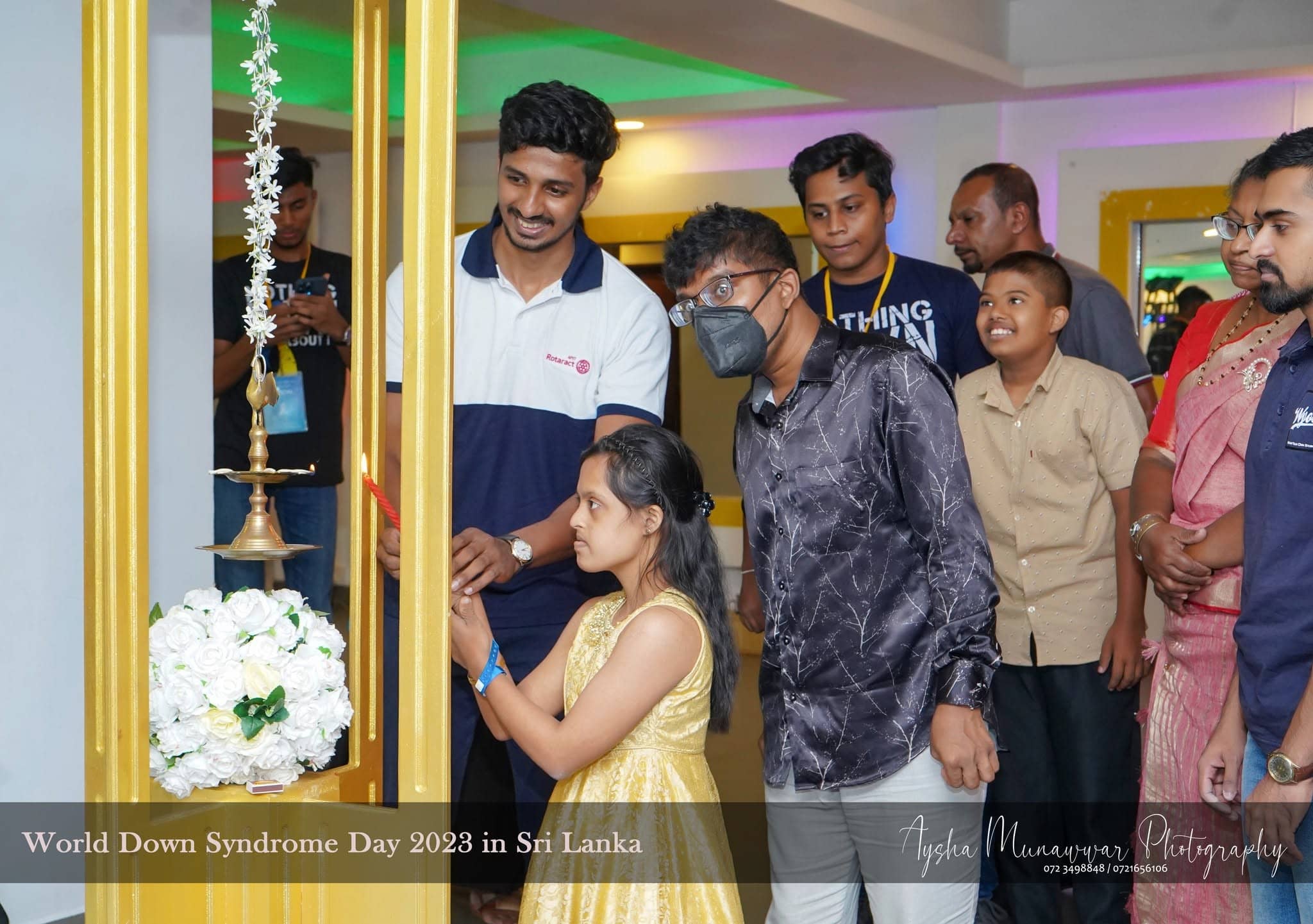 Lighting the traditional oil lamp at World Down Syndrome Day in Sri Lanka